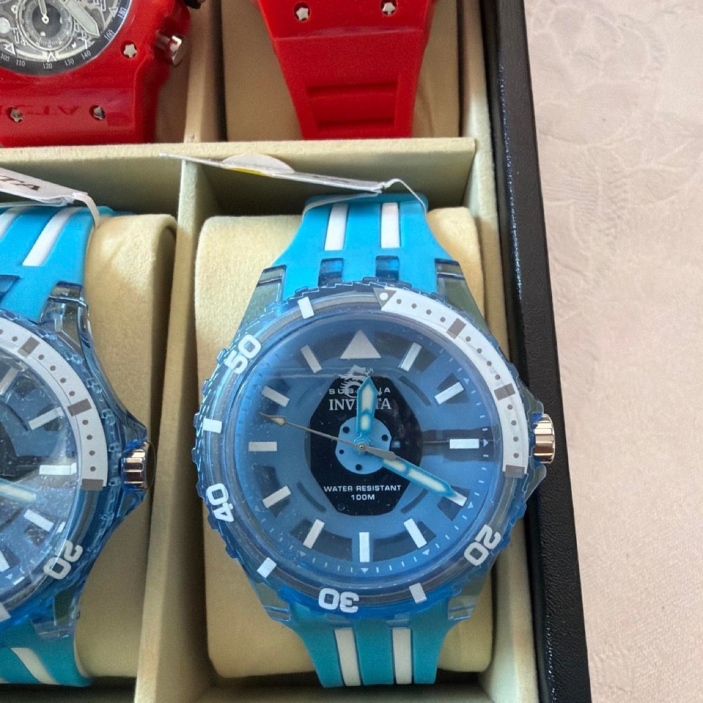 Invicta blue watch with white stripes on the band Blue, Red, yellow, Green